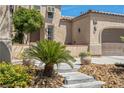 Charming home featuring stone accents, desert landscaping, and a well-manicured lawn at 7206 Laramie Ave, Las Vegas, NV 89113