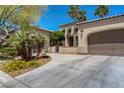 Charming single Gathering home with desert landscaping, palm trees, and a driveway at 7206 Laramie Ave, Las Vegas, NV 89113