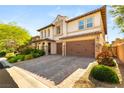 Beautiful home boasting a brick driveway, two-car garage, and meticulously maintained landscaping at 749 Middle Beach St, Las Vegas, NV 89138