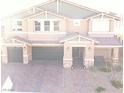 Charming two-story home with a three-car garage, a stone veneer and a well manicured brick driveway at 7855 Skyler Falls Ln, North Las Vegas, NV 89084