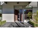 A modern home entrance featuring a sleek door, clean lines, and manicured landscaping at 8925 W Flamingo Rd # 117, Las Vegas, NV 89147
