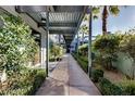 A covered walkway with lush greenery leads through this well-maintained community at 8925 W Flamingo Rd # 117, Las Vegas, NV 89147