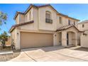 Two-story home with a two-car garage, desert landscaping, and a welcoming covered front porch at 9073 Spoonbill Ridge Pl, Las Vegas, NV 89143