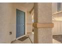 Close-up of the blue front door with desert landscaping and stylish accents at 9073 Spoonbill Ridge Pl, Las Vegas, NV 89143