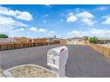 Property showcasing a mailbox, ample parking, and partially fenced perimeter, complemented by a serene blue sky at 952 Balzar Ave, Las Vegas, NV 89106