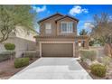 Inviting two-story home features a neatly kept front yard and a spacious two-car garage at 1104 Aspen Cliff Dr, Henderson, NV 89011