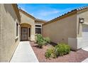 A welcoming front entrance with desert landscaping and a secure gate at 1212 E Rome Blvd, North Las Vegas, NV 89086