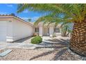 Inviting front of home with desert landscaping, sidewalk and decorative plants offers great curb appeal at 130 Park Ridge Ln, Henderson, NV 89002