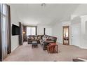 Spacious living room boasts ample seating, neutral tones, and abundant natural light from large windows at 130 Park Ridge Ln, Henderson, NV 89002