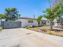 Charming single-story home featuring stucco walls, mature trees and gated access at 1704 S 8Th St, Las Vegas, NV 89104