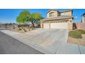 Attractive exterior featuring three-car garage, desert landscaping with trees, and convenient driveway at 1740 Flores Ln, Henderson, NV 89012