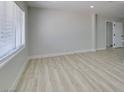 Bright living room with fresh paint, wood flooring, white trim and modern windows at 1825 Howard Ave, Las Vegas, NV 89104