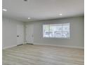 Bright living room with neutral walls, wood flooring, modern trim, and natural light at 1825 Howard Ave, Las Vegas, NV 89104