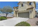 Attractive two-story home with an attached garage, neutral stucco, and easy-care landscaping at 1952 W Hammer Ln, North Las Vegas, NV 89031