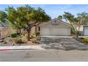 Charming single-story home featuring a spacious three car garage and lush landscaping at 2158 Shubert Ave, Henderson, NV 89052