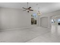 Spacious living room with large windows providing natural light, neutral walls, and elegant archway to the rest of the home at 2158 Shubert Ave, Henderson, NV 89052