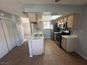Functional kitchen featuring tiled floors, countertops, and stainless steel appliances at 227 N Lamb Blvd # A, Las Vegas, NV 89110
