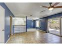 Bright living room with tile flooring, ceiling fan, and sliding glass doors to the patio at 2349 Wooster Cir # A, Las Vegas, NV 89108