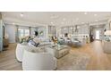 Spacious open-concept living area with light wood floors and a modern kitchen at 243 Paraggi Bay Dr, Henderson, NV 89011