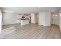 Bright, open-concept living space featuring hardwood floors, white walls, and an eat-in kitchen with a center island at 2637 Begonia Falls Ave # 87, North Las Vegas, NV 89081