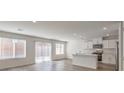 Open-concept living space featuring hardwood floors, white walls, and an eat-in kitchen with stainless appliances at 2637 Begonia Falls Ave # 87, North Las Vegas, NV 89081
