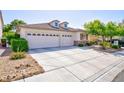 Stylish home featuring a two-car garage, attractive landscaping, and a well-maintained driveway at 270 New River Cir, Henderson, NV 89052