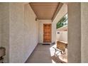 Inviting entryway with a solid wood door and neutral colored exterior paint at 270 New River Cir, Henderson, NV 89052