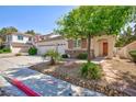 Beautiful home with stone accents, a two-car garage, and desert landscaping at 270 New River Cir, Henderson, NV 89052