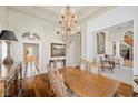 Elegant dining room with hardwood floors, large chandelier, and decorative moldings at 3102 La Mirada Ave, Las Vegas, NV 89120
