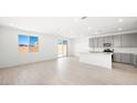 Bright open concept kitchen features white countertops, island, stainless appliances and backsplash at 340 Taylor St, Henderson, NV 89015