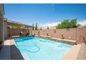 Beautiful backyard pool with a water feature and a covered patio perfect for outdoor relaxation and entertaining at 3468 Isle Dr, Las Vegas, NV 89141
