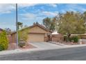 Inviting single-story home with a well-maintained front yard, desert landscaping and an attached two-car garage at 4204 Sprints Race Ave, North Las Vegas, NV 89084