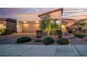 The home's exterior features desert landscaping, a two-car garage, and a well-lit facade at 44 Alta Cascata Pl, Henderson, NV 89011