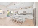 A bright, spacious kitchen with a large island, stainless steel appliances, and modern pendant lighting at 44 Alta Cascata Pl, Henderson, NV 89011