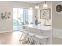 Modern kitchen island with white countertops, bar stool seating, and pendant lighting at 44 Alta Cascata Pl, Henderson, NV 89011