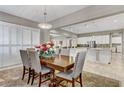 Elegant dining room featuring a large table, comfortable seating, and stylish chandelier, open to the kitchen at 480 Heritage Bridge Ave, Henderson, NV 89011