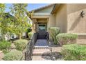 Charming front entrance with landscaped walkway, black iron railing and gate, and covered porch at 480 Heritage Bridge Ave, Henderson, NV 89011
