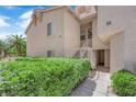 Well-maintained home exterior showing clean landscaping, white staircase and stucco at 5000 Red Rock St # 259, Las Vegas, NV 89118
