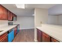 Clean, spacious kitchen layout with wood-look floors and updated stainless steel appliances at 5021 River Glen Dr # 45, Las Vegas, NV 89103