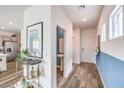 Welcoming entryway featuring wood-look floors and an accent wall, leading to a powder room and kitchen at 516 Red Lovebird Ave # Lot 1242, Henderson, NV 89011
