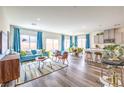 Bright, open living room and kitchen with modern furnishings and lots of natural light from large windows at 516 Red Lovebird Ave # Lot 1242, Henderson, NV 89011