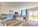 Cozy living room with stylish furniture, a modern media console, and sliding doors to a backyard at 516 Red Lovebird Ave # Lot 1242, Henderson, NV 89011