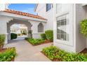 Landscaped walkway, covered entrance, and view of garages add curb appeal at 5201 S Torrey Pines Dr # 1221, Las Vegas, NV 89118