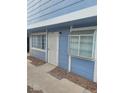 A cozy condo featuring wood paneling, security door, a double-paned window, and a small garden box window at 5335 Rod Ct # 102, Las Vegas, NV 89122