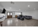 Spacious living room featuring wood flooring, recessed lighting, and double doors at 603 Palmhurst Dr, Las Vegas, NV 89145