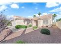 Single story home featuring desert landscaping, a two car garage, and a light colored exterior at 6231 Curlew Dr, Las Vegas, NV 89122