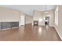 Open-concept living room with wood floors, fireplace, and a dining area in the background at 6231 Curlew Dr, Las Vegas, NV 89122