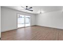 A well-lit living room features a sliding glass door and wood flooring at 6305 Fairwood Ave, Las Vegas, NV 89107