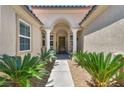 Inviting front entrance with well-manicured landscaping and a covered entryway at 6423 Grayback Dr, North Las Vegas, NV 89084