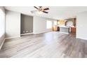 Open-concept living room featuring hard surface floors, ceiling fan and lots of natural light at 7371 Catmint St, Las Vegas, NV 89113
